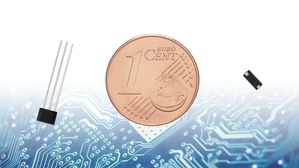 A 1 euro cent coin is placed between two small Reed switches, all set against a blue and white circuit board background, highlighting the tiny size of these magnetic sensing technologies. by Standex Detect