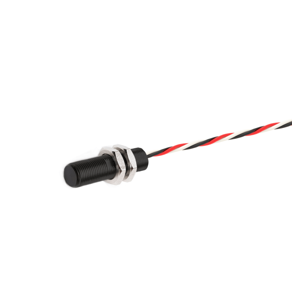 A cylindrical black AH Series Analog Hall Sensor with two hexagonal metal nuts, attached to a twisted red, black, and white wire, isolated on a white background. by Standex Detect