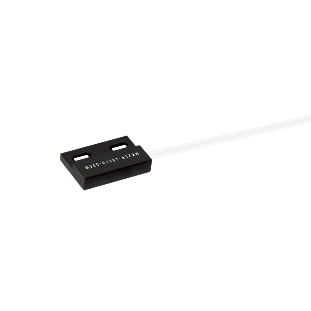 A rectangular black magnetic proximity sensor with screw mount holes and white wires extending from one end, isolated on a white background. The sensor has text printed on its surface. by Standex Detect